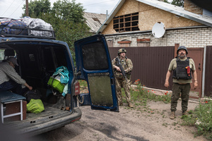 The ‘White Angels’ police unit officers monitors drones during a civilian evacuation.