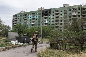 A police officer from the ‘White Angels’ police unit seen near a building damaged by a Russian airstrike.
