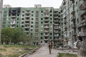 A police officer from the ‘White Angels’ police unit seen near a building damaged by a Russian airstrike.