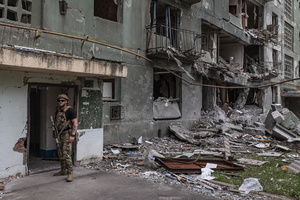 A police officer from the ‘White Angels’ police unit seen near a building damaged by a Russian airstrike.