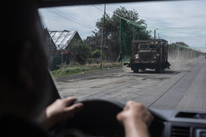 A military vehicle protected by metal grilles seen on a road during an evacuation of civilians by the Ukrainian police unit ‘White Angels’ .