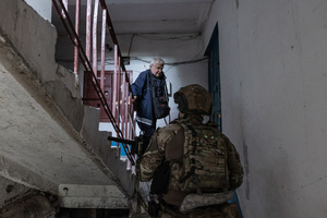An old man seen being evacuated by the ‘White Angels’ police unit.