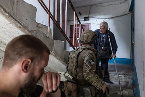 An old man seen being evacuated by the ‘White Angels’ police unit.