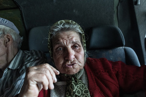 An old woman seen as civilians are evacuated by the ‘White Angels’ police unit.