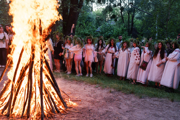 Dozens of people sing traditional Ukrainian folk songs in front of a bonfire as part of the tradition of the festival in "Mamaeva Sloboda" open-air museum. Ukraine celebrates Ivan Kupala, a traditional Slavic midsummer festival that blends ancient pagan roots with Christian traditions and honors water, fire and nature.