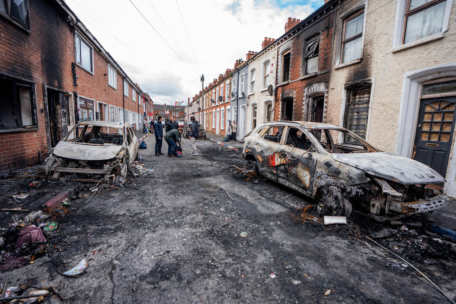 The burnt-out cars and buildings seen in the Templemore area following the night riots. The city erupted into flames as locals took to the streets to protest against the stabbing of a North Belfast man by a Sudanese national refugee.  Road blockades were set up all over Belfast, bringing much of the city to a standstill. The protestors are demanding a stop to immigration into Northern Ireland.
