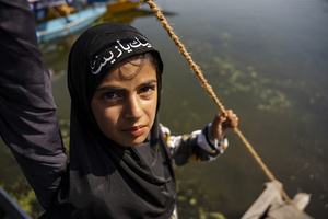 A Shia Muslim girl looks on during a Muharram procession, commemorating the martyrdom of Imam Hussain and his companions in the Battle of Karbala. Muharram is the first month of the Islamic calendar. Shia Muslims observe Muharram as a period of mourning to commemorate the martyrdom of Imam Hussain, the grandson of Prophet Muhammad. Imam Hussain was martyred on the 10th day of Muharram, during the historic Battle of Karbala in 680 CE.