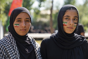 Kashmiri Shia Muslim girls with painted Palestinian flag and Iranian flags on their faces look on as they participate in a Muharram procession commemorating the martyrdom of Imam Hussain and his companions in the Battle of Karbala. Muharram is the first month of the Islamic calendar. Shia Muslims observe Muharram as a period of mourning to commemorate the martyrdom of Imam Hussain, the grandson of Prophet Muhammad. Imam Hussain was martyred on the 10th day of Muharram, during the historic Battle of Karbala in 680 CE.