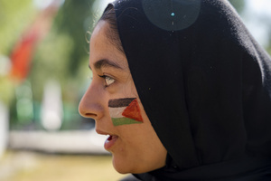 A Kashmiri Shia Muslim girl with a painted Palestinian flag on her face looks on as she participates in a Muharram procession commemorating the martyrdom of Imam Hussain and his companions in the Battle of Karbala. Muharram is the first month of the Islamic calendar. Shia Muslims observe Muharram as a period of mourning to commemorate the martyrdom of Imam Hussain, the grandson of Prophet Muhammad. Imam Hussain was martyred on the 10th day of Muharram, during the historic Battle of Karbala in 680 CE.