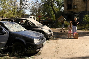 Local residents seen near cars damaged as a result of a missile strike. Following a devastating overnight bombardment in which Russia launched 74 missiles and 496 attack drones, Kyiv has declared July 3, 2026, a city-wide Day of Mourning to honor the victims. At least 25 people were killed and over 80 injured across the capital as direct strikes heavily damaged residential apartment blocks, leaving active search and rescue operations scrambling to locate residents still believed to be trapped under the rubble.