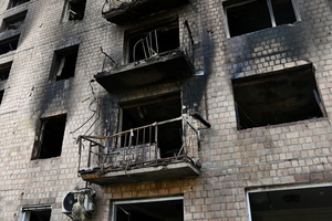 An apartment building remains partially destroyed by a Russian strike. Following a devastating overnight bombardment in which Russia launched 74 missiles and 496 attack drones, Kyiv has declared July 3, 2026, a city-wide Day of Mourning to honor the victims. At least 25 people were killed and over 80 injured across the capital as direct strikes heavily damaged residential apartment blocks, leaving active search and rescue operations scrambling to locate residents still believed to be trapped under the rubble.