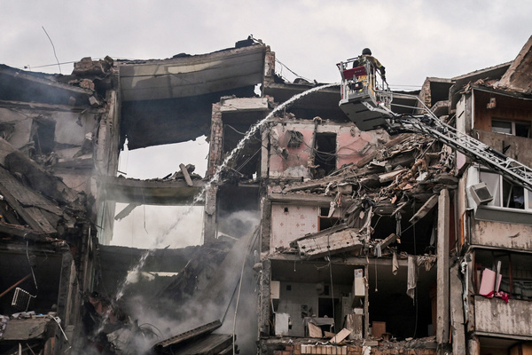 Firefighters extinguish a fire in an apartment building partially destroyed by a Russian strike. Russia struck Ukraine's Kyiv region with ballistic missiles on July 6, killing at least eight people and wounding dozens, authorities said, on the eve of a NATO summit in Turkey.