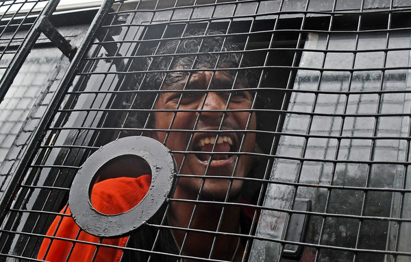 A demonstrator is seen shouting slogans from inside a police van after being detained during a protest. Cockroach Janata Party (CJP) supporters gathered in different areas of the city and protested against alleged paper leaks and irregularities in major national medical entrance examinations. Supporters are seeking resignation of Union Education Minister Dharmendra Pradhan and they demand greater accountability and reforms in India's education system.