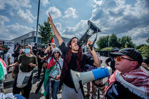 Pro-Palestinian protestors chant slogans through megaphones during a rally outside Elbit Systems weapons factory. Pro-Palestinian protestors gathered outside Elbit Systems factory in Filton, Bristol to accuse the arms company of supplying Israel with weaponry and drones for its war in Gaza.