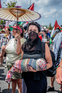 A pro-Palestinian protestor carries a symbol of a dead baby, accusing Israel of killing children in Gaza during the rally Pro-Palestinian protestors gathered outside Elbit Systems factory in Filton, Bristol to accuse the arms company of supplying Israel with weaponry and drones for its war in Gaza.