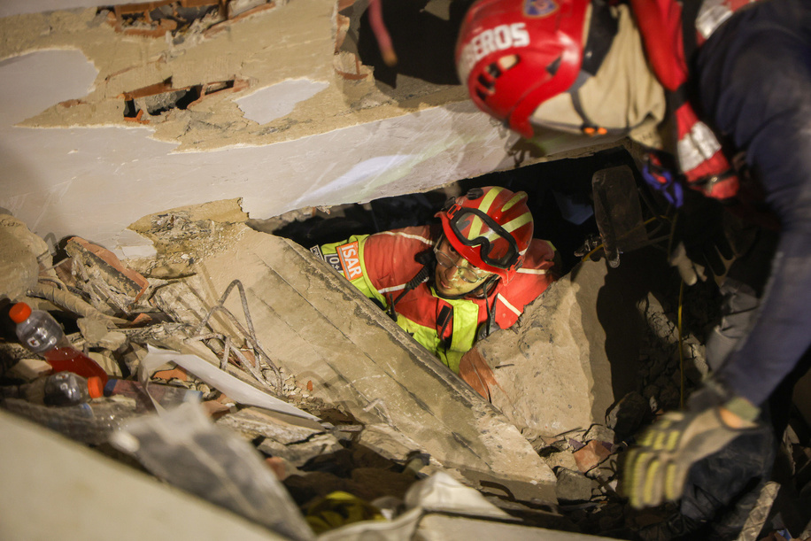 An Ecuadorian firefighter emerges from a hole in the rubble during a rescue operation in La Guaira. The Venezuelan government declared a state of emergency and, with support from international rescue teams, launched large-scale search, rescue, and humanitarian operations following the devastating earthquakes that struck the country's northern coast. The response came after powerful earthquakes on June 24, 2026, caused widespread destruction in Caracas, La Guaira, and surrounding areas, resulting in thousands of deaths and injuries.