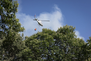 A firefighting helicopter seen near the small town of Casillas. The wildfire has prompted an extreme fire danger alert across central Spain including Madrid and surrounding regions.