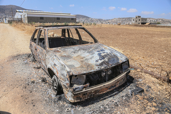 General view of the remains of a burned-out car belonging to Palestinians after it was set ablaze by Jewish settlers near the Palestinian village of Salem, east of Nablus in the northern occupied West Bank.