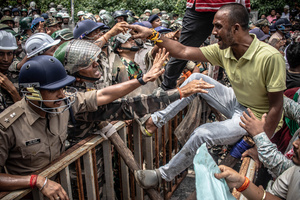 A demonstrator on police barricade yells at the officers during a rally. Students staged a march to the state assembly, amplifying ongoing protests against alleged irregularities in examinations conducted by the Jharkhand Public Service Commission and the Jharkhand Staff Selection Commission.