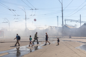 A firefighter and local citizens seen walking past the Smouldering ruins of the Pochayna book market following a devastating overnight Russian military attack. On the night of August 16, 2026, a massive Russian air strike on Kyiv caused severe destruction and a large-scale fire at the "Pochaina" book market (formerly known as Petrivka) in the Obolon district. The enemy attack completely burned down several rows of trading pavilions containing books and stationery just ahead of the new school year. Emergency response teams worked at the scene to extinguish the blaze, which spread across a vast area. According to preliminary reports from city authorities, at least three people were injured as a result of the overnight attack. The destroyed marketplace had operated in the capital for nearly 30 years and stood as one of the largest hubs for book trade in Ukraine.