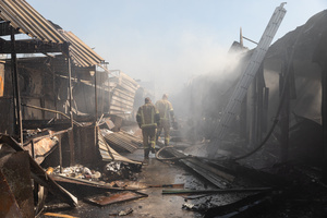 Two firefighters seen investigating the extensive damage inside the Pochaina book market after a Russian missile strike caused a massive fire . On the night of August 16, 2026, a massive Russian air strike on Kyiv caused severe destruction and a large-scale fire at the "Pochaina" book market (formerly known as Petrivka) in the Obolon district. The enemy attack completely burned down several rows of trading pavilions containing books and stationery just ahead of the new school year. Emergency response teams worked at the scene to extinguish the blaze, which spread across a vast area. According to preliminary reports from city authorities, at least three people were injured as a result of the overnight attack. The destroyed marketplace had operated in the capital for nearly 30 years and stood as one of the largest hubs for book trade in Ukraine.