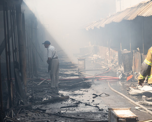 A firefighter seen inspecting the aftermath of a massive fire caused by a Russian military attack at the historic Pochaina book market . On the night of August 16, 2026, a massive Russian air strike on Kyiv caused severe destruction and a large-scale fire at the "Pochaina" book market (formerly known as Petrivka) in the Obolon district. The enemy attack completely burned down several rows of trading pavilions containing books and stationery just ahead of the new school year. Emergency response teams worked at the scene to extinguish the blaze, which spread across a vast area. According to preliminary reports from city authorities, at least three people were injured as a result of the overnight attack. The destroyed marketplace had operated in the capital for nearly 30 years and stood as one of the largest hubs for book trade in Ukraine.