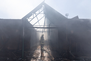 A firefighter seen inspecting the charred remains of the Pochayna book market following a destructive nighttime attack. On the night of August 16, 2026, a massive Russian air strike on Kyiv caused severe destruction and a large-scale fire at the "Pochaina" book market (formerly known as Petrivka) in the Obolon district. The enemy attack completely burned down several rows of trading pavilions containing books and stationery just ahead of the new school year. Emergency response teams worked at the scene to extinguish the blaze, which spread across a vast area. According to preliminary reports from city authorities, at least three people were injured as a result of the overnight attack. The destroyed marketplace had operated in the capital for nearly 30 years and stood as one of the largest hubs for book trade in Ukraine.