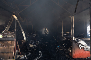 A firefighter is seen walking through the Smouldering debris of the Pochayna book market following a destructive nighttime missile strike. On the night of August 16, 2026, a massive Russian air strike on Kyiv caused severe destruction and a large-scale fire at the "Pochaina" book market (formerly known as Petrivka) in the Obolon district. The enemy attack completely burned down several rows of trading pavilions containing books and stationery just ahead of the new school year. Emergency response teams worked at the scene to extinguish the blaze, which spread across a vast area. According to preliminary reports from city authorities, at least three people were injured as a result of the overnight attack. The destroyed marketplace had operated in the capital for nearly 30 years and stood as one of the largest hubs for book trade in Ukraine.