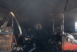 A firefighter is seen walking through the Smouldering debris of the Pochayna book market following a destructive nighttime missile strike. On the night of August 16, 2026, a massive Russian air strike on Kyiv caused severe destruction and a large-scale fire at the "Pochaina" book market (formerly known as Petrivka) in the Obolon district. The enemy attack completely burned down several rows of trading pavilions containing books and stationery just ahead of the new school year. Emergency response teams worked at the scene to extinguish the blaze, which spread across a vast area. According to preliminary reports from city authorities, at least three people were injured as a result of the overnight attack. The destroyed marketplace had operated in the capital for nearly 30 years and stood as one of the largest hubs for book trade in Ukraine.