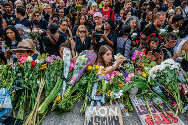 Mourners lay flowers at the base of Nelson's Column as thousands of Londoners held a vigil in Trafalgar Square in honour of Professor Jason Arday following his recent death. The mourners blamed the press for hounding the discredited Cambridge professor in a racist witch hunt which they claimed drove him to suicide.