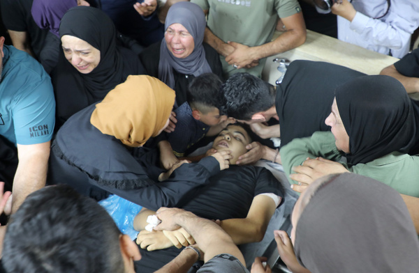 (EDITOR'S NOTE; Images depict death)
Relatives and friends of a 14-year-old Palestinian boy, Islam Ajouri, weep over his body at the morgue of Rafidia Hospital. Islam Ajouri, 14 years old, was shot and killed by Israeli forces during a military raid on the Askar refugee camp near Nablus. Medical personnel from the Palestinian Red Crescent Society reported that the teenager suffered a fatal gunshot wound to the chest and was pronounced dead after being rushed to the hospital in critical condition. Two others were wounded during stone-throwing clashes in the Askar refugee camp.