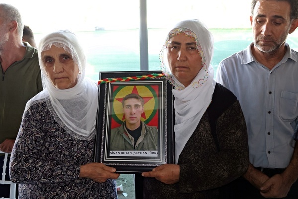 Kurdish women are seen holding a photograph of a guerrilla who died in the conflict during the ceremony. Three days of condolences were established and a memorial program was organized in the city of Diyarbakir in Turkey for 49 Kurdistan Workers' Party (PKK) guerrillas who died in armed clashes with the Turkish army on different dates in the past years and whose identities have just been announced. Abdullah Ocalan, the leader of the armed Kurdish PKK party who has been in prison in Turkey for 26 years, had decided two years ago to disarm his party and start peace talks with the state of Turkey.