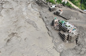 (EDITOR'S NOTE : Image taken with a drone).
An aerial view shows buildings and infrastructure damaged along the swollen Trishuli River following a massive flash flood triggered by an avalanche of ice and rock in the upper Lhende River on the Tibetan side. The sudden flood swept through communities along the Bhote Koshi and Trishuli river, destroying homes, roads and bridges and leaving a widespread devastation downstream.