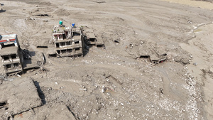 (EDITOR'S NOTE : Image taken with a drone).
An aerial view shows buildings and infrastructure damaged along the swollen Trishuli River following a massive flash flood triggered by an avalanche of ice and rock in the upper Lhende River on the Tibetan side. The sudden flood swept through communities along the Bhote Koshi and Trishuli river, destroying homes, roads and bridges and leaving a widespread devastation downstream.