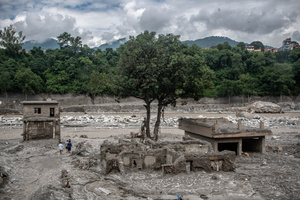 Nuwakot district is almost entirely cut off and paralyzed after catastrophic flash floods, triggered by upstream glacier collapse, annihilated infrastructure, including this crucial asphalt road section, in Trishuli. The widespread erosion and massive surge of mud have fundamentally altered the landscape and severed critical connectivity, isolating survivors across the devastated district and making a mockery of any recovery timeline as thousands face displacement.