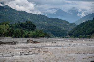 Nuwakot district is almost entirely cut off and paralyzed after catastrophic flash floods, triggered by upstream glacier collapse, annihilated infrastructure, including this crucial asphalt road section, in Trishuli. The widespread erosion and massive surge of mud have fundamentally altered the landscape and severed critical connectivity, isolating survivors across the devastated district and making a mockery of any recovery timeline as thousands face displacement.
