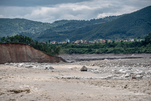 Nuwakot district is almost entirely cut off and paralyzed after catastrophic flash floods, triggered by upstream glacier collapse, annihilated infrastructure, including this crucial asphalt road section, in Trishuli. The widespread erosion and massive surge of mud have fundamentally altered the landscape and severed critical connectivity, isolating survivors across the devastated district and making a mockery of any recovery timeline as thousands face displacement.