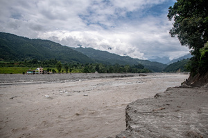 Nuwakot district is almost entirely cut off and paralyzed after catastrophic flash floods, triggered by upstream glacier collapse, annihilated infrastructure, including this crucial asphalt road section, in Trishuli. The widespread erosion and massive surge of mud have fundamentally altered the landscape and severed critical connectivity, isolating survivors across the devastated district and making a mockery of any recovery timeline as thousands face displacement.