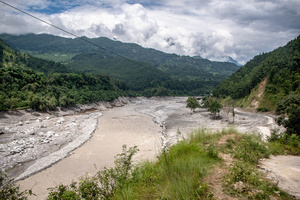 Nuwakot district is almost entirely cut off and paralyzed after catastrophic flash floods, triggered by upstream glacier collapse, annihilated infrastructure, including this crucial asphalt road section, in Trishuli. The widespread erosion and massive surge of mud have fundamentally altered the landscape and severed critical connectivity, isolating survivors across the devastated district and making a mockery of any recovery timeline as thousands face displacement.