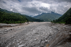 Nuwakot district is almost entirely cut off and paralyzed after catastrophic flash floods, triggered by upstream glacier collapse, annihilated infrastructure, including this crucial asphalt road section, in Trishuli. The widespread erosion and massive surge of mud have fundamentally altered the landscape and severed critical connectivity, isolating survivors across the devastated district and making a mockery of any recovery timeline as thousands face displacement.