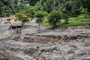 Nuwakot district is almost entirely cutoff and paralyzed after catastrophic flash floods, triggered by upstream glacier collapse, annihilated infrastructure, including this crucial asphalt road section, in Trishuli. The widespread erosion and massive surge of mud have fundamentally altered the landscape and severed critical connectivity, isolating survivors across the devastated district and making a mockery of any recovery timeline as thousands face displacement.