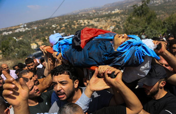 (EDITOR'S NOTE: Image depicts death)
Palestinian mourners seen carrying the body of Omar al-Toubasi who was killed during clashes with Israeli soldiers and Jewish settlers in the village of Hajja. Omar was killed during an attack by Jewish settlers on his home, which also left four members of his family seriously wounded. Omar was a medical student at An-Najah National University.