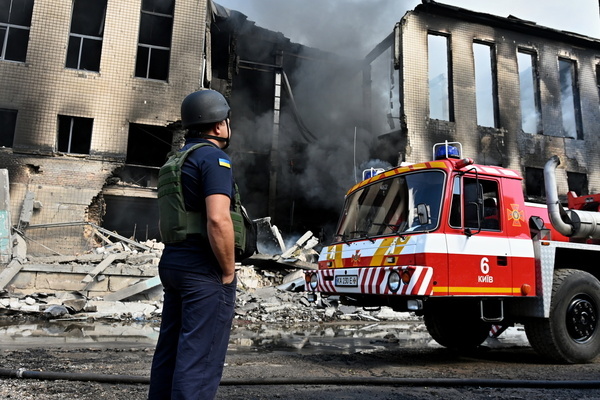 A member of an emergency service seen near the site that was hit by Russian drone strikes. According to local authorities, the attack caused destruction and fires across five districts, resulting in at least two fatalities and several injuries. Air defense forces reported the interception of two ballistic missiles, 31 cruise missiles, and 142 drones. Debris strikes also caused severe damage to residential buildings, warehouses, and an educational facility in the Holosiivskyi and Solomianskyi districts, where emergency services worked to rescue trapped residents.