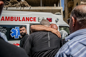 Mourners hug in Kfar Roummane, southern Lebanon, ahead of the funeral of 12 members of the same family and a paramedic killed by Israeli airstrikes. At least 4,381 people were killed and 12,402 wounded by Israeli attacks in Lebanon between March 2 and September 7, 2026, according to Lebanon's ministry of health.