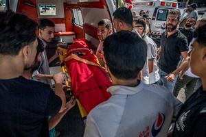 (EDITORS NOTE: Image depicts death)
Mourners take the body of a child out of an ambulance in Kfar Roummane, southern Lebanon, ahead of the funeral of a family killed by an Israeli airstrike. At least 4,381 people were killed and 12,402 wounded by Israeli attacks in Lebanon between March 2 and September 7, 2026, according to Lebanon's ministry of health.