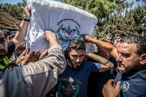 Mourners carry the coffin of Ali Shahrour, a paramedic with Al Risala Scouts, who was killed by an Israeli airstrike in Kfar Roummane, southern Lebanon. At least 4,381 people were killed and 12,402 wounded by Israeli attacks in Lebanon between March 2 and September 7, 2026, according to Lebanon's ministry of health.