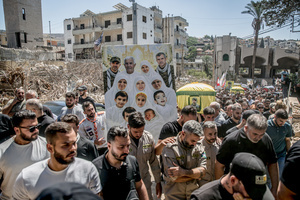 Mourners carry pictures of those killed in Kfar Roummane, southern Lebanon, during the funeral of a family killed by an Israeli airstrike. At least 4,381 people were killed and 12,402 wounded by Israeli attacks in Lebanon between March 2 and September 7, 2026, according to Lebanon's ministry of health.