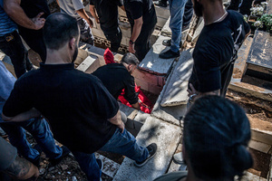 The body of a child is placed in a grave in Kfar Roummane, southern Lebanon, during the funeral of a family killed by an Israeli airstrike. At least 4,381 people were killed and 12,402 wounded by Israeli attacks in Lebanon between March 2 and September 7, 2026, according to Lebanon's ministry of health.