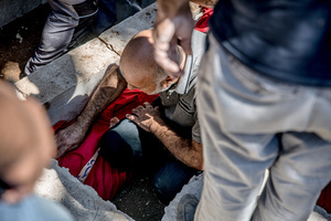 A mourner sits in the grave of a child at a cemetery in Kfar Roummane, southern Lebanon, during the funeral of a family killed by an Israeli airstrike. At least 4,381 people were killed and 12,402 wounded by Israeli attacks in Lebanon between March 2 and September 7, 2026, according to Lebanon's ministry of health.