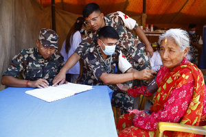 An elderly woman gets her pressure checked during the Teej festival at Pashupatinath Temple. Married and unmarried Hindu women observe fasting during the festival. Married women traditionally abstain from food and water while praying for the longevity, peace, and prosperity of their husbands and families, while unmarried women fast in the hope of being blessed with good husbands.